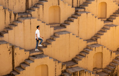 Full length of man moving up on steps