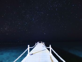 View of pier at night