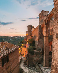 Buildings in city against sky during sunset