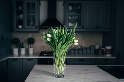 Flower vase on table at home