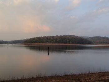 Scenic view of lake against sky at sunset