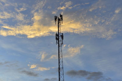 Low angle view of communications tower against sky