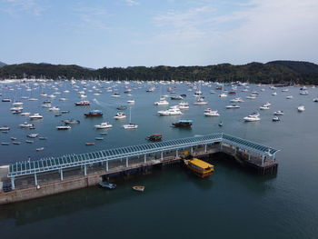 High angle view of sailboats moored on sea against sky