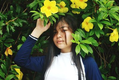 Portrait of happy woman with plants