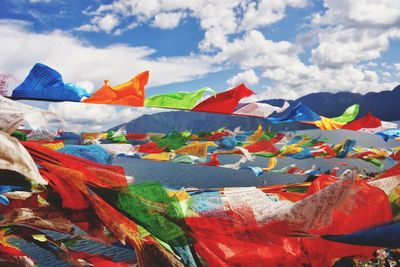 Low angle view of flags against sky