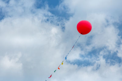 Low angle view of balloons against sky