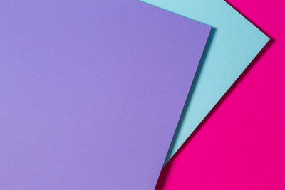 High angle view of multi colored paper against blue background