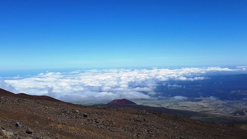 Scenic view of volcanic landscape against blue sky