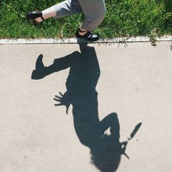Low section of people with shadow on street