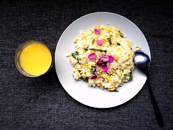 Directly above shot of scrambled eggs and orange juice on table