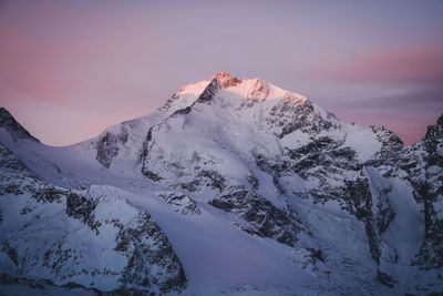 Scenic view of snowcapped mountains against sky during sunset