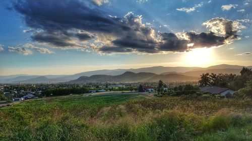 Scenic view of field against sky during sunset