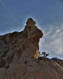 Low angle view of rocky mountains against sky