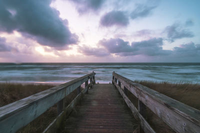 Pier over sea against sky