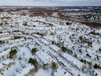 High angle view of snow covered buildings in city