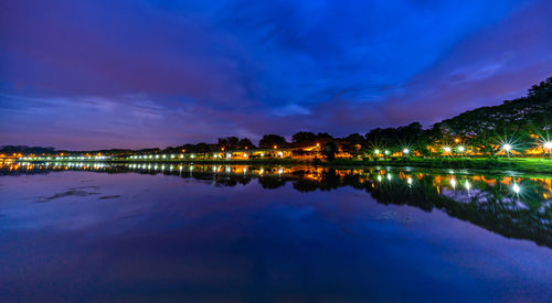 Scenic view of lake against sky at night