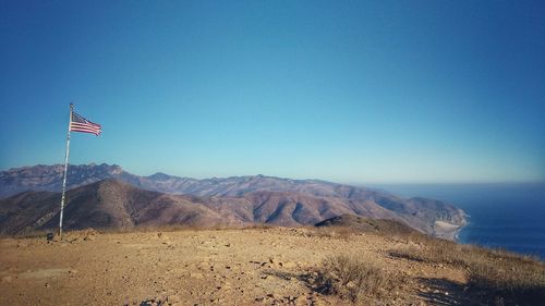 Scenic view of mountains against clear blue sky