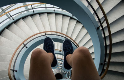 Low section of woman moving down stairs