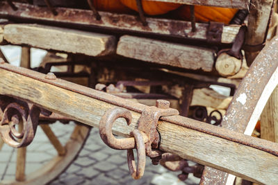 Close-up of rusty chain on wood