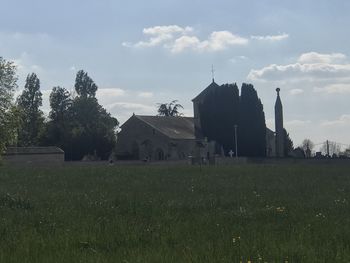 Houses on field against sky