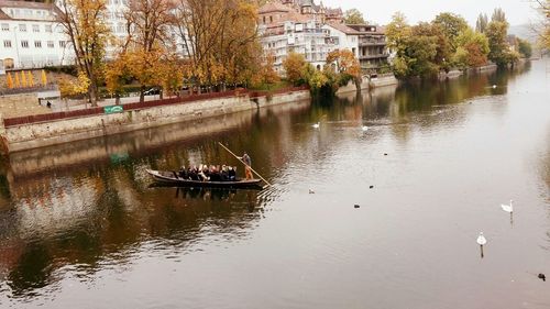 Boats in river with buildings in background