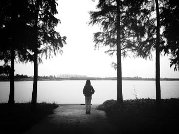 Rear view of woman standing in water