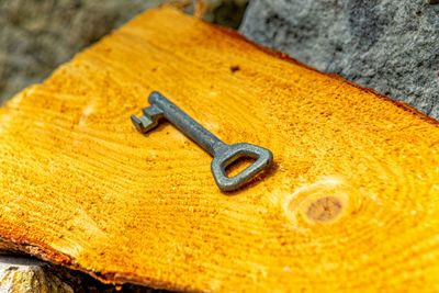 Close-up of rusty metal on wood