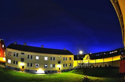 Illuminated built structure against blue sky