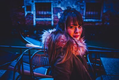 Portrait of smiling young woman at night