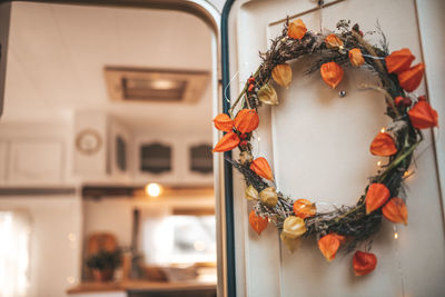Close-up of wreath hanging in door at home