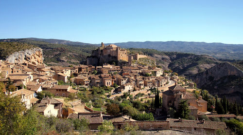 Townscape against clear blue sky