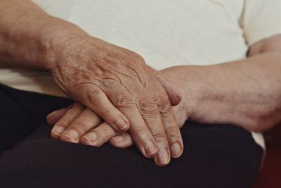 Midsection of senior man with hands clasped
