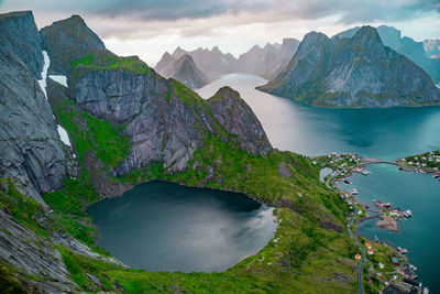 Scenic view of lake, mountains and sea against cloudy sky, lofoten, norway