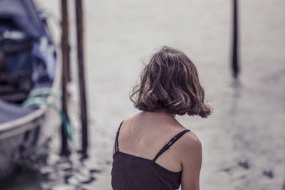 Rear view of woman standing outdoors