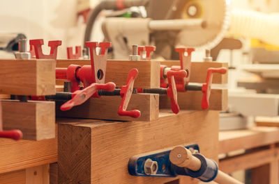 Close up of carpenter fastening board with clamps. carpentry workshop