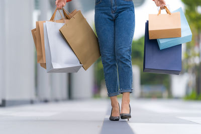 Low section of woman standing on paper