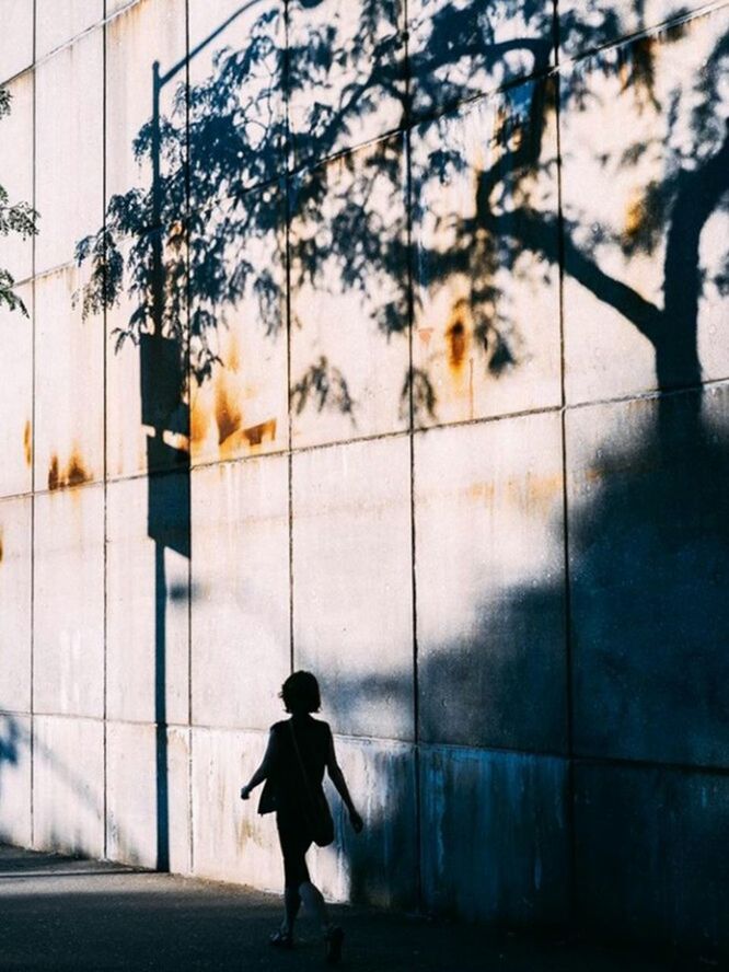 PERSON WALKING ON SIDEWALK