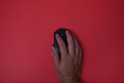 Close-up of hand against red background