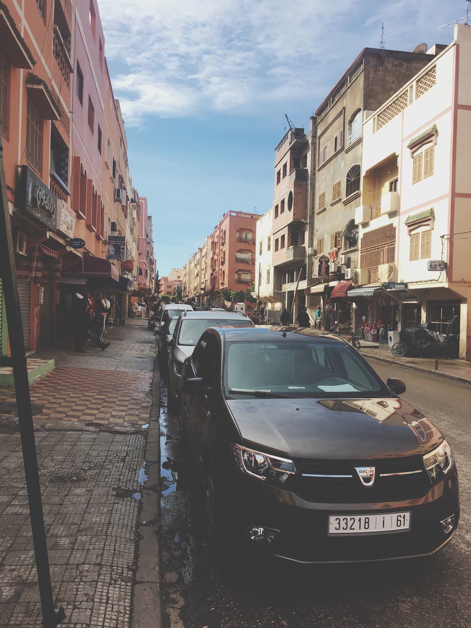 architecture, car, building exterior, land vehicle, transportation, built structure, street, mode of transport, sky, city, outdoors, day, stationary, no people