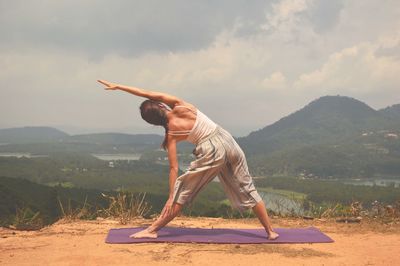 Full length of senior man on mountain against sky