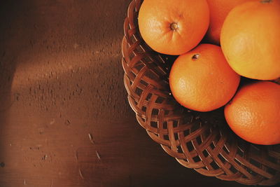 High angle view of oranges in basket on table