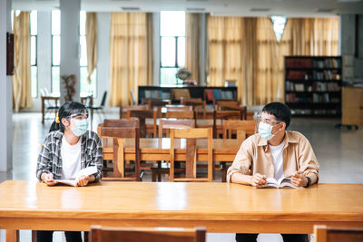 Young couple sitting on table