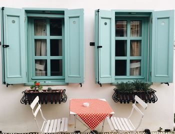 Potted plants on window of building