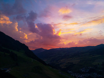 Scenic view of dramatic sky over silhouette landscape