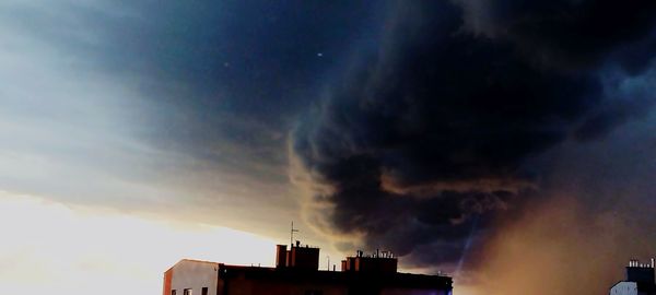 Low angle view of buildings against sky during sunset