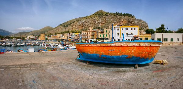 Boats in calm sea with buildings in background
