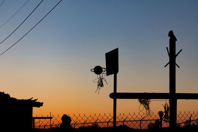 Silhouette birds against sky during sunset