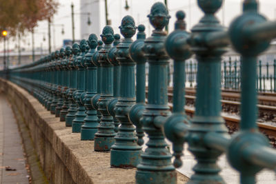 Close-up of metal railing against building