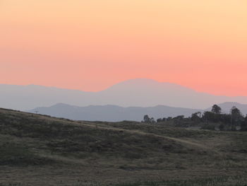 Scenic view of field against sky during sunset