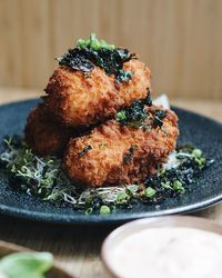 Close-up of deep fried food with dip at table